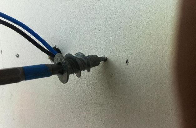 The drywall dowels are screwed into the drywall with a screwdriver.