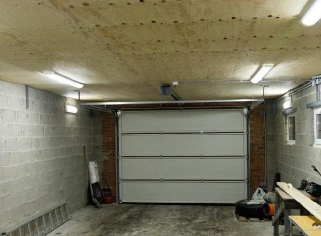 The wiring of lighting in the garage with his hands